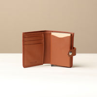 Open Brown RFID card case showing aluminum pop-up holder and additional card slots