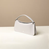 Side view of white Penelope Mini small leather handbag for versatile everyday use