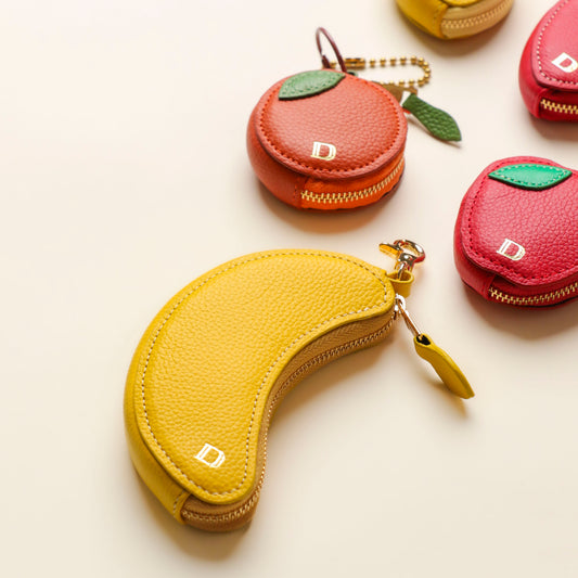 Banana, strawberry, and lemon leather keychains by Danilo’s – handcrafted fruit-shaped accessories with gold hardware