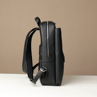 Black backpack on a beige background