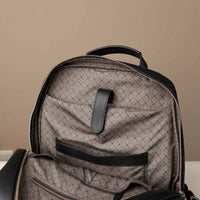 Gray backpack with black pattern on a beige background