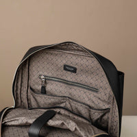 Gray backpack with a diamond pattern on a beige background