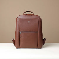 Brown leather backpack on a beige background