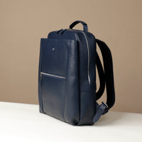 Navy blue backpack on a beige background