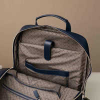 Backpack with quilted pattern and blue accents on a beige background