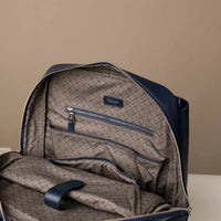 Backpack with quilted pattern and visible brand logo on a beige background