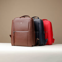 Three backpacks in brown, black, and red on a beige background