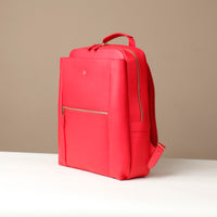 Red backpack on a beige background