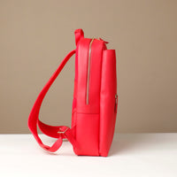 Red backpack on a beige background