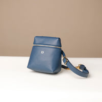 Blue handbag with a strap on a beige background
