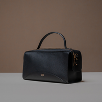 Angled View of Black Avela Bag with top handle and detachable strap