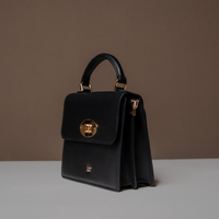 Slightly Side View of Black Nelda Bag elegant leather handbag with detachable shoulder strap on a neutral background