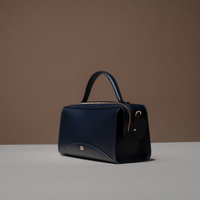 Angled View of Blue Avela Bag with top handle and detachable strap