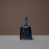 Side View of Blue Avela Bag with top handle and detachable strap