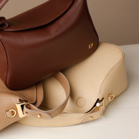 Brown Hold Bag by Danilos in smooth leather on a beige hold bag