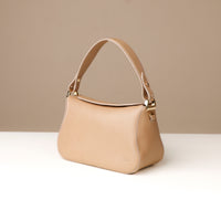 Side view of beige Hold Bag by Danilos in smooth leather
