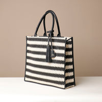 Side View of Raffia Mercatto tote bag, a lightweight, artisanal woven bag crafted from natural raffia.