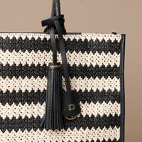 Close Up View of Raffia Mercatto tote bag, a lightweight, artisanal woven bag crafted from natural raffia.