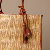 Close Up View of Raffia Mercatto tote bag, a lightweight, artisanal woven bag crafted from natural raffia.