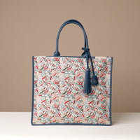 A collection of Raffia Mercatto Tote Bags in various patterns and color combinations, featuring a common design with leather details.