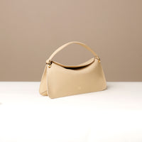 Side view of beige Penelope Mini small leather handbag for versatile everyday use