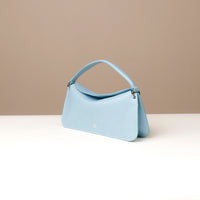 Side view of light blue Penelope Mini small leather handbag for versatile everyday use