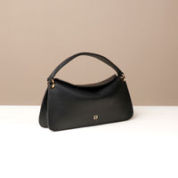 Side view of black Penelope Mini small leather handbag for versatile everyday use