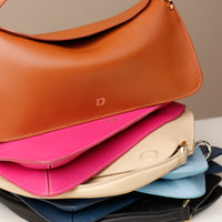 Close up of stacked Penelope Mini small leather handbag for versatile everyday use