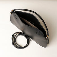 Open interior of black Penelope Mini small leather handbag for versatile everyday use