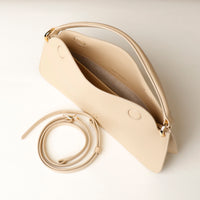 Open interior of beige Penelope Mini small leather handbag for versatile everyday use
