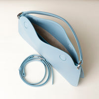 Open interior of light blue Penelope Mini small leather handbag for versatile everyday use