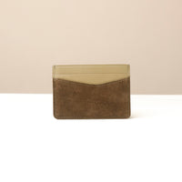 green suede leather Danilos cardholder with beige top and brown bottom on a white background
