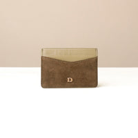 green suede Danilos cardholder with a beige interior on a white background