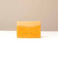 Yellow suede leather Danilos cardholder on a beige background