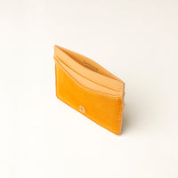 Yellow suede leather cardholder with danilos name on a light beige background
