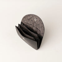 Black quilted leather wallet on a white background