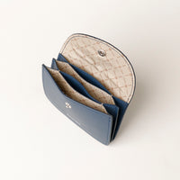Blue leather wallet with beige interior on a white background