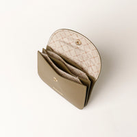 Open beige wallet with quilted interior on a white background