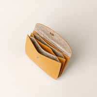 Yellow wallet with a textured interior on a light gray background