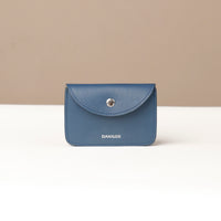 Blue wallet with 'DANILOS' branding on a beige background