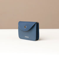 Blue wallet with 'DANILIOS' branding on a beige and white background