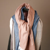 Scarf draped over a mannequin against a neutral background