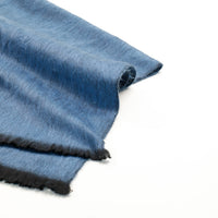 Blue fabric with black edges on a white background