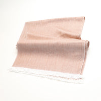 Beige fabric with white fringe on a white background