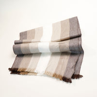 Striped scarf with brown, beige, and white colors on a white background