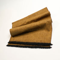 Brown scarf with black fringe on a white background