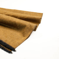 Brown fabric with black fringe on a white background