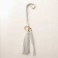 White stylish decorative accessories designed to add personality and flair to bags, keys, or everyday items. Perfect for gifting or styling.