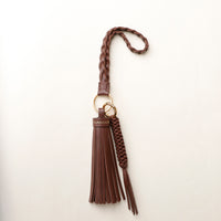 Brown stylish decorative accessories designed to add personality and flair to bags, keys, or everyday items. Perfect for gifting or styling.