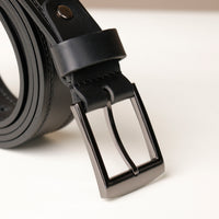 Close‑up of stitched detail on black smooth leather belt